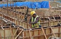 Group of construction workers fabricating ground beam formwork Royalty Free Stock Photo
